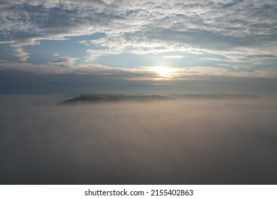 Between the clouds- hills getting from inversion layer on the ground and other layer of high altitude atmospheric clouds,stunning aerial panorama landscape view