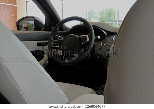 Between front leather seats inside a car with\
combined black and white\
upholstery