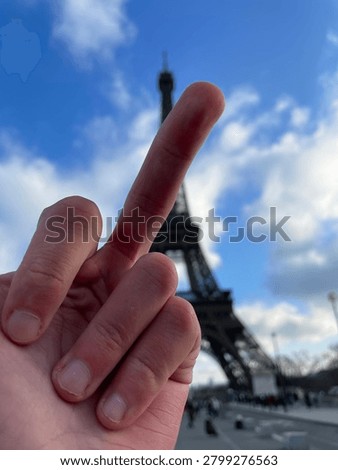 Between a hand and Eiffel tower
