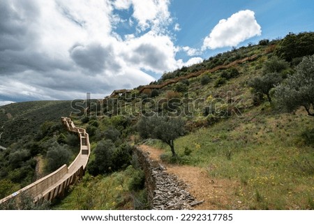 Between hills, the Passadiços do Côa, part of the wooden structure with a length of 930 meters and 890 steps in Foz Côa, Portugal on a cloudy day