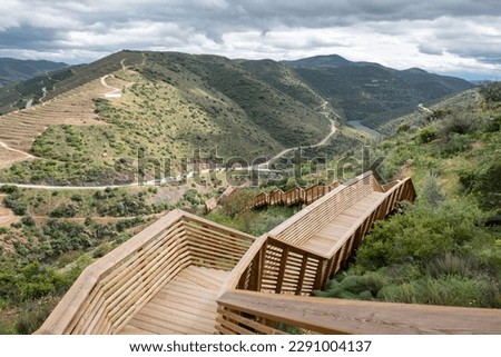 Between hills, mountains and a road in the background, the Passadiços do Côa, a wooden structure 930 meters long and 890 steps, in Foz Côa, Portugal