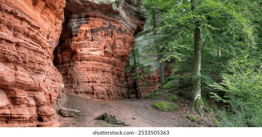 Between impressive sandstone cliffs, the Altschlosspfad leads hikers through the Palatinate Forest. The narrow passages are surrounded by towering rocks, telling millions of years of Earth's history. - Powered by Shutterstock