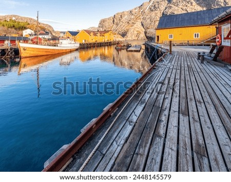 Beuatiful Village Nusjord with old yellow Norway fisher houses on a sunny day at Lofoten Island, Norway