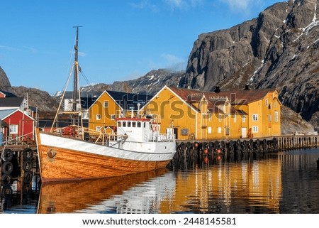 Beuatiful Village Nusjord with old yellow Norway fisher houses on a sunny day at Lofoten Island, Norway
