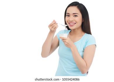 Beutiful Young Asian Woman Eating Greek Yogurt, Isolated On White