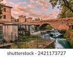 Bevagna, Perugia, Umbria, Italy: ancient bridge, canal of the old mills and waterfalls in the medieval town

