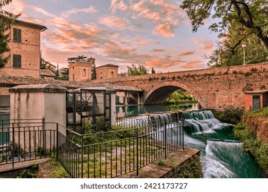 Bevagna, Perugia, Umbria, Italy: ancient bridge, canal of the old mills and waterfalls in the medieval town