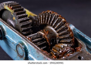 Bevel gear lubricated with grease. A mechanism for transmitting torque in a mechanical device. Dark background. - Powered by Shutterstock