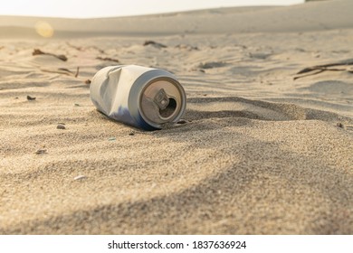 Beverage Can In Sand Dune. Problem Of Environmental Pollution.