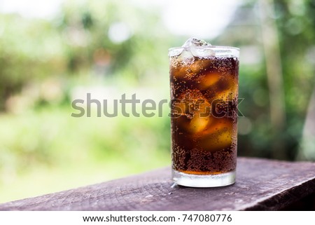 Beverage from cola in glass with ice on the wood,beverage in summer is sparkling water