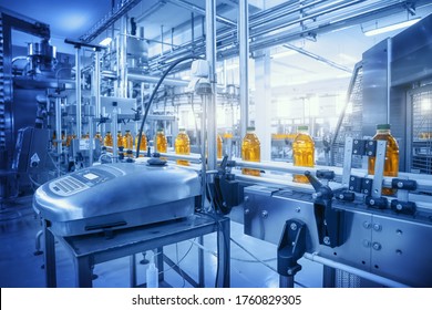 Beverage factory, Conveyor belt with juice in bottles, Industrial Interior in blue color, food and drink production line process. - Shutterstock ID 1760829305