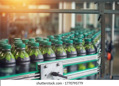 Beverage Factory, Conveyor Belt With Juice In Bottles, Industrial Interior, Food And Drink Production Line Process.