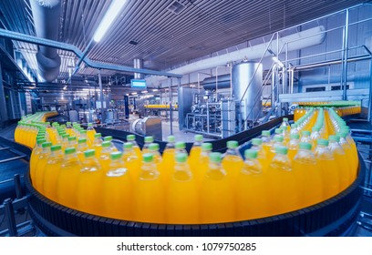 Beverage factory interior. Conveyor with bottles for juice or water. Modern equipments - Shutterstock ID 1079750285