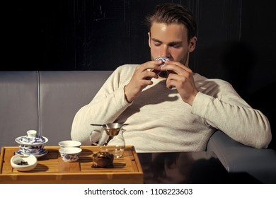 Beverage, Food, Cuisine. Brew Tea Concept. Tea Party, Ceremony, Time. Relaxation Lounge Relax Man Drink Tea On Sofa In Cafe