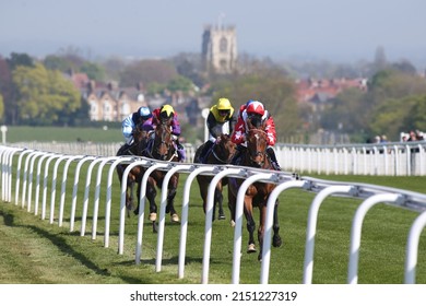BEVERLEY RACECOURSE, EAST YORKSHIRE, UK : 21 April 2022 : The sight of racehorses finishing a race on The Westwood with St Marys Parish Church, Beverley in the background