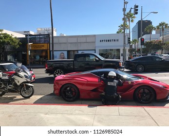 Beverly Hills, CA: June 3, 2018: A Beverly Hills Police Officer talking with a driver in an exotic vehicle.  Beverly Hills is an upscale city in Southern California.