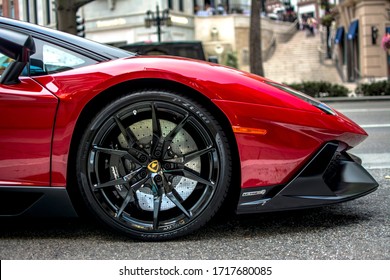 Beverly Hills, Los Angeles, Year 2016: Lamborghini Aventador LP720-4 profile. Red supercar with street background. Black wheel rim.