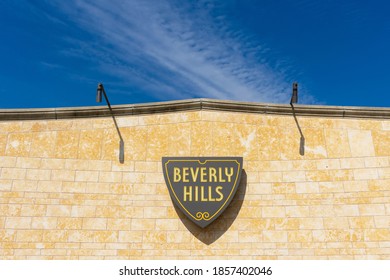 Beverly Hills Shield Sign On The Beige Wall Under Beautiful Blue Sky In Background - Beverly Hills, California, USA - 2020