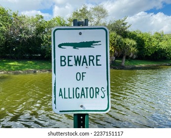 Beware of alligators warning sign next to Florida canal and lake - Powered by Shutterstock