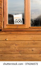 Beware Of The Dog Please Close The Gate Sign In Window On Brown Shed