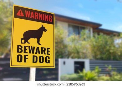 A Beware of Dog Sign in front of a gated home. Warning to visitors or burglars. Security and protection in a residential home concept.