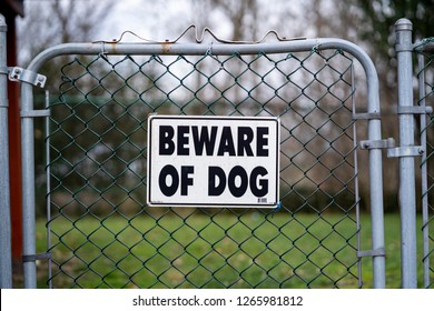 Beware Of Dog Sign On Back Yard Fence