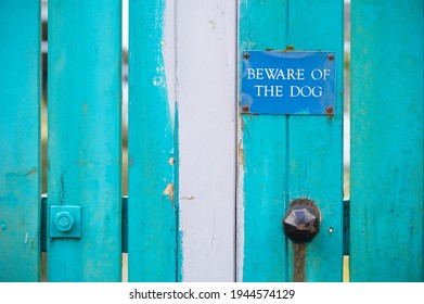 Beware Of Dog Sign On Blue Wooden House Gate