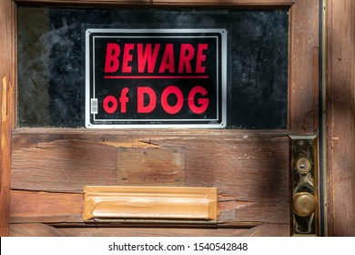 Beware Of Dog Sign On Front Door Of House