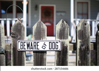 Beware Of Dog Sign For Security On Wooden Fence Outside Of Home