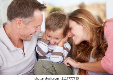 Beware The Tickle Monster. Shot Of Parents Tickling Their Young Son.