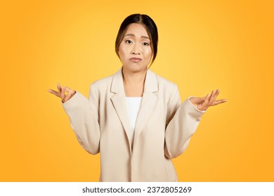 Bewildered Asian millennial woman stands confronted with difficult choice, facial expressions confused, pensive. Engaged in deep thought, weighs options, encapsulating challenge of decision making - Powered by Shutterstock