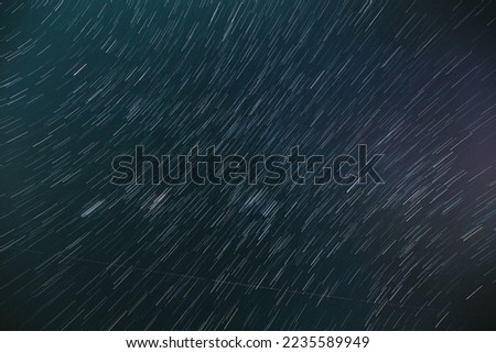 Bewitching Illusion Of Star Trails. 5k . Spin Of Unusual Amazing Stars Effect In Sky. Rotate Of Sky Background. Meteors Trace On Night Dark Blue Sky Background. , .