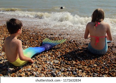 Bexhill,East Sussex/UK 09-01-18 Bexhill's Annual, Free, Festival Of The Sea Event 2018 . A Colourful Young Mermaid And A Merboy Watch An Adult Mermaid Swimming In The English Channel