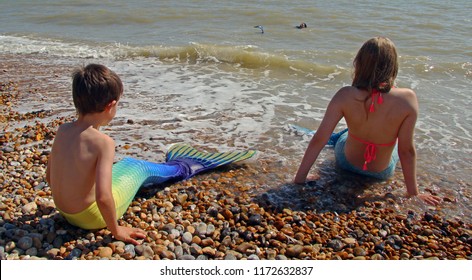 Bexhill,East Sussex/UK 09-01-18 Bexhill's Annual, Free, Festival Of The Sea Event 2018 . A Colourful Young Mermaid And A Merboy Watch An Adult Mermaid Swimming In The English Channel