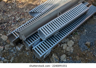 Bexhill-on-Sea, East Sussex, United Kingdom - July 10th 2022: Pile of ACO RainDrain channel drain sections with galvanised steel grating - Shutterstock ID 2240091551