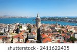 Beyoglu Region and Galata tower, one of the ancient symbols of Istanbul. Crowded city skyline and Bosphorus in the background. Aerial shot with a drone

