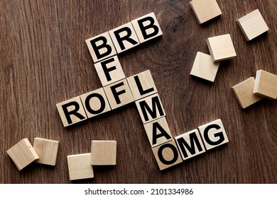 BFF, ROFL, OMG and LMAO, BRB .Be Right Back. cut text messages on wooden cubes in the form of a crossword puzzle. Internet slang.