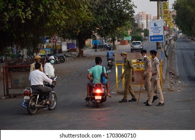 Bharuch, Gujarat / India - April 05 2020: Covid 19 Corona Virus 21 Days Lockdown In India. Indian Police Man On Duty To Stop People From Roaming In City. Selective Focus On Man And Background Blur.