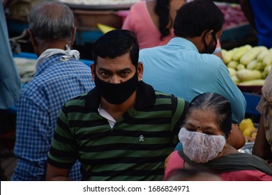 Bharuch, Gujarat / India - March 20, 2020: An Indian Man And Woman Wearing MEDICAL MASK For Protection, Safety, Prevention Of COVID 19 CORONA VIRUS Buying Vegetables Fruit In Market Crowd In Lockdown.