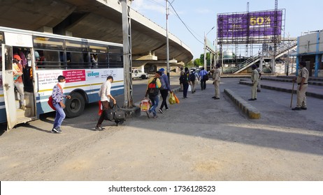 Bharuch, Gujarat / India: May 20, 2020: Indian Migrant Workers Affected Due To COVID 19 Corona Virus Nationwide Lockdown. Migrant Workers Returning Back Home Special Trains Bus Police Railway Station.