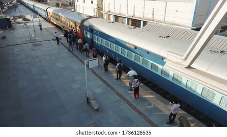 Bharuch, Gujarat / India: May 20, 2020: Indian Migrant Workers Affected Due To COVID 19 Corona Virus Nationwide Lockdown. Migrant Workers Returning Back Home Special Trains Bus Police Railway Station.