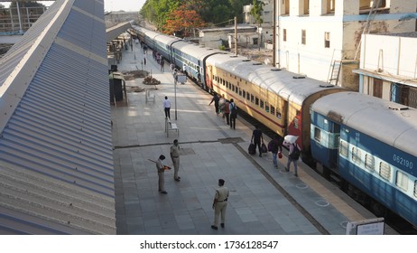 Bharuch, Gujarat / India: May 20, 2020: Indian Migrant Workers Affected Due To COVID 19 Corona Virus Nationwide Lockdown. Migrant Workers Returning Back Home Special Trains Bus Police Railway Station.