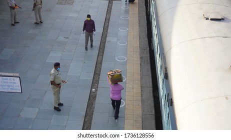 Bharuch, Gujarat / India: May 20, 2020: Indian Migrant Workers Affected Due To COVID 19 Corona Virus Nationwide Lockdown. Migrant Workers Returning Back Home Special Trains Bus Police Railway Station.