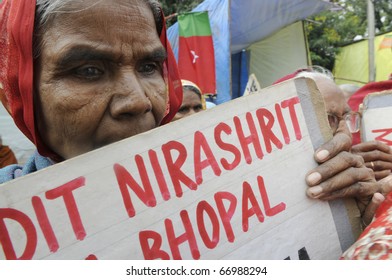 BHOPAL- DECEMBER 2: A grim looking old woman victim holds a banner during the rally to mark the 26th year of the Bhopal Gas Disaster, in Bhopal - India on December 2, 2010.