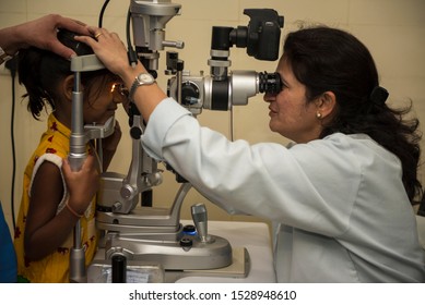 Bhopal / India 12 March 2019 Indian Woman Doctor Checking And Examination On Eye With Little Girl Child In Hospital At Bhopal Madhya Pradesh Central India