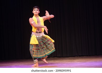BHUBANESWAR, ODISHA, INDIA - December 28 2021: Indian Male Classical dancer performs Odissi dance in the International Odissi Dance Festival at Utkal Rangamancha Auditorium in Bhubaneswar, India.