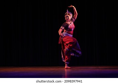 BHUBANESWAR, ODISHA, INDIA - December 28 2021: Indian female dancer performs Odissi dance in the International Odissi Dance Festival 2021 at Utkal Rangamancha Auditorium in Bhubaneswar, India.
