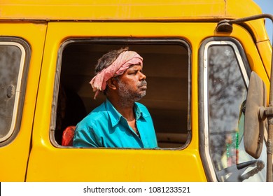 Bhubaneswar, Odisha, India - January 8, 2014 - Portrait Of A Indian Truck Driver With Yellow Truck At Odisha.