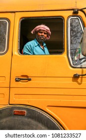 Bhubaneswar, Odisha, India - January 8, 2014 - Portrait Of A Indian Truck Driver With Yellow Truck At Odisha.