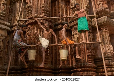 Bhubaneswar, Odisha, India - May 15, 2008: Group of men on scaffolding cleaning and restoring the ancient Rajarani Hindu Temple in Bhubaneswar, India. 